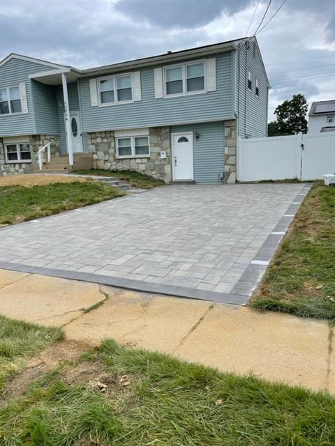 A house with a brick driveway in front of it