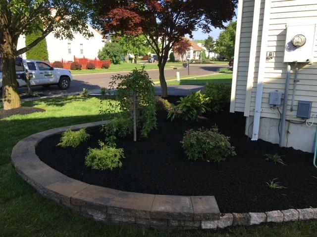 A white truck is parked in front of a white house