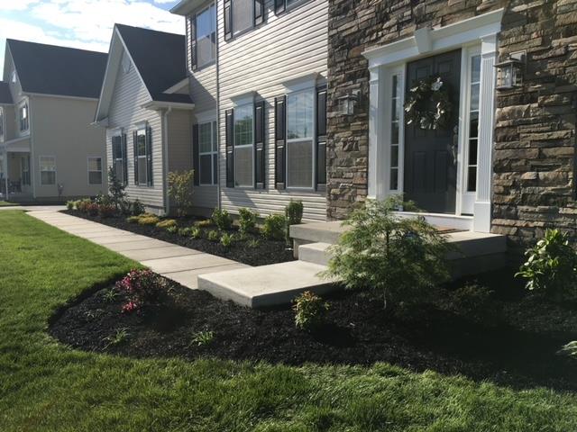 There is a walkway leading to the front door of a house.