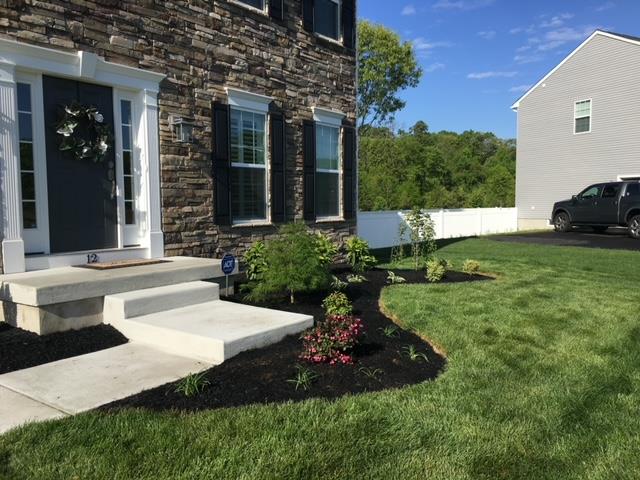 The front of a house with a car parked in front of it.
