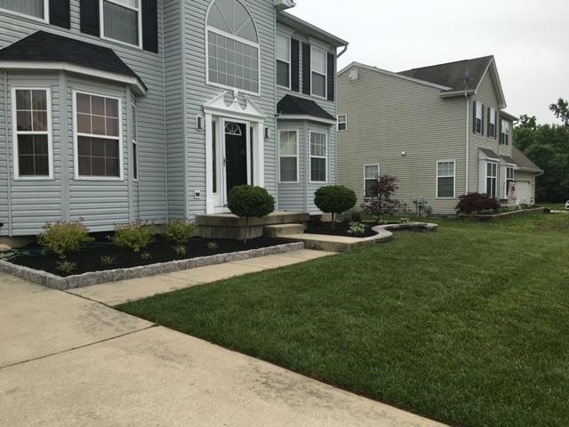 A large house with a lush green lawn in front of it.
