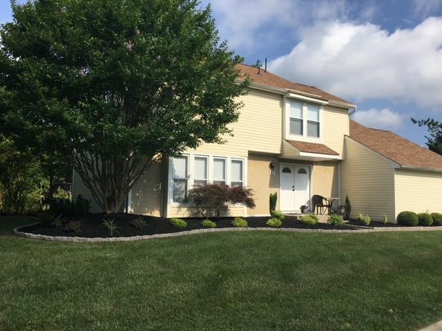 A large house with a lush green lawn in front of it