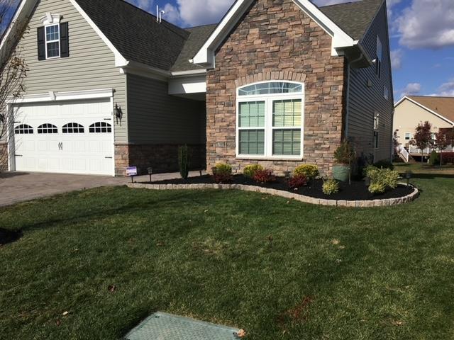 A house with a large lawn in front of it