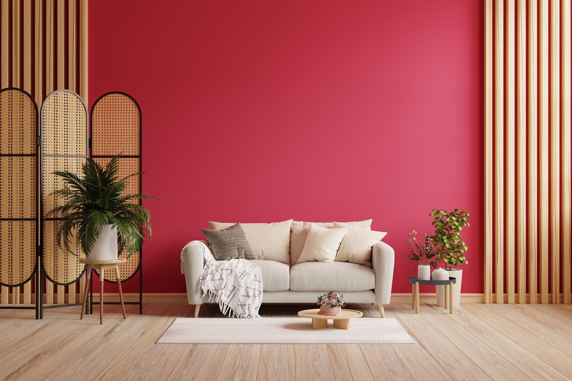 A living room with a trendy magenta wall, a sofa, and decor.