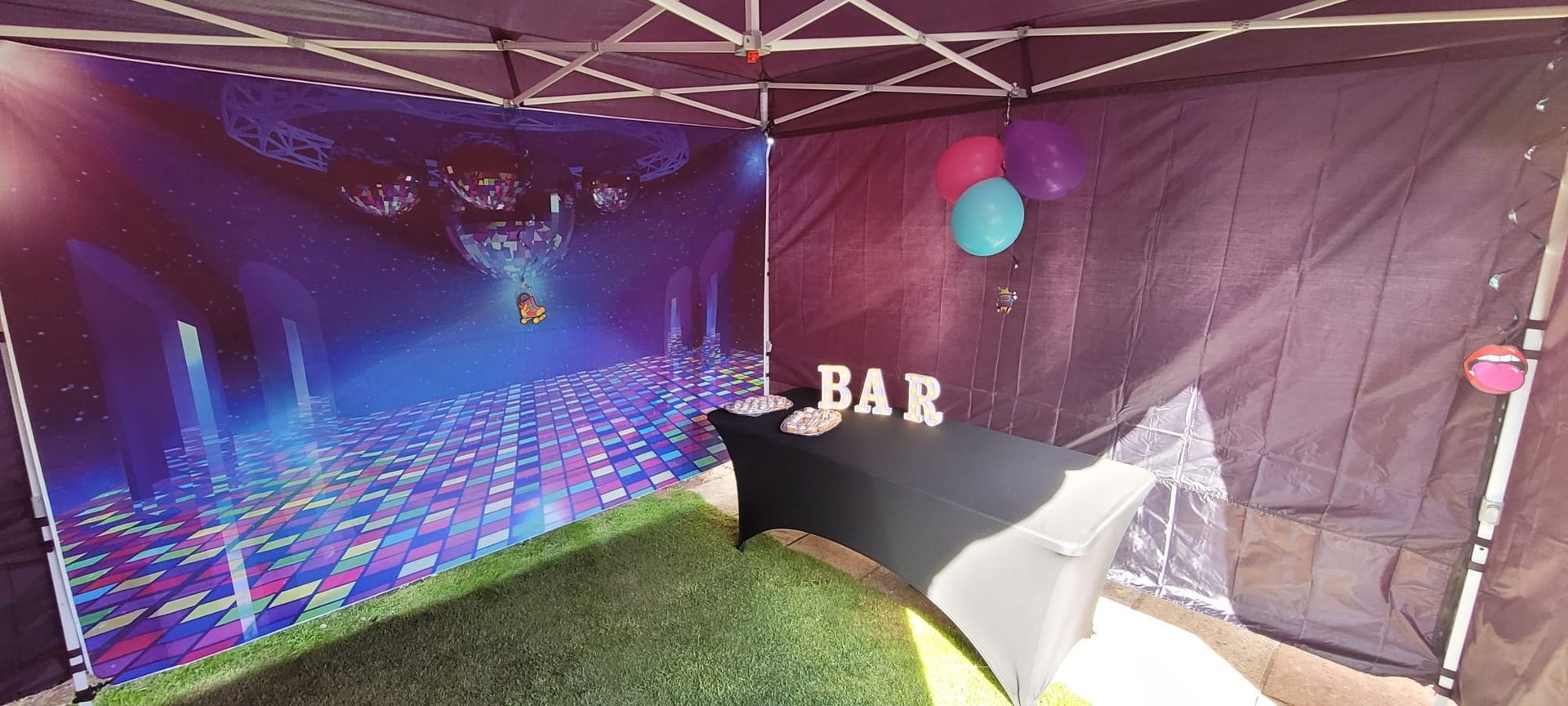 A tent with a picture of a stage and the word bar on it.