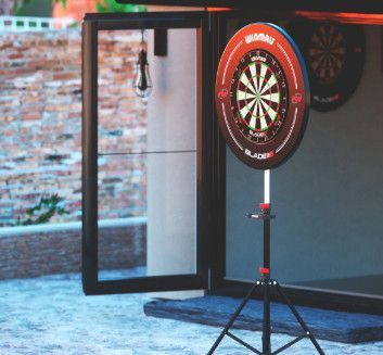 A dart board on a stand outside of a building