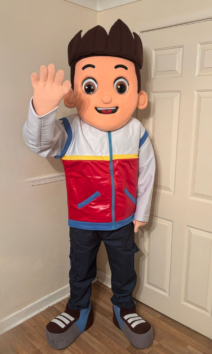 A mascot from paw patrol is standing in front of a door.