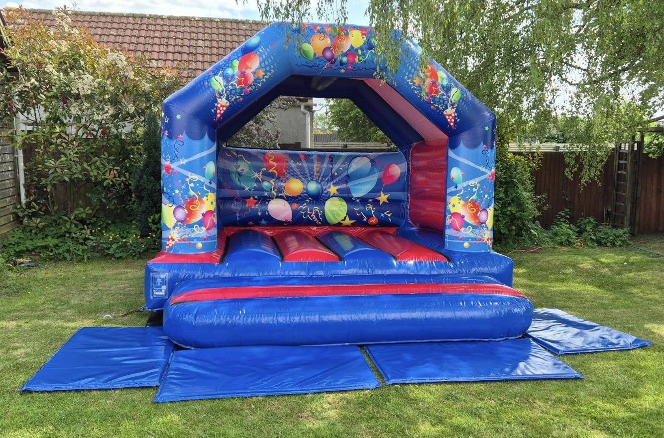 A blue and red bouncy house in a room