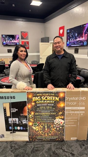 Two people stand behind a 