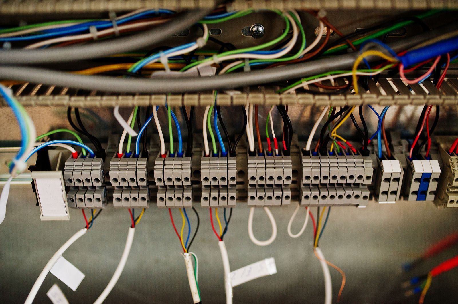 Close-up of server rack with multiple connected network cables of various colors, indicating data transfer and connections.