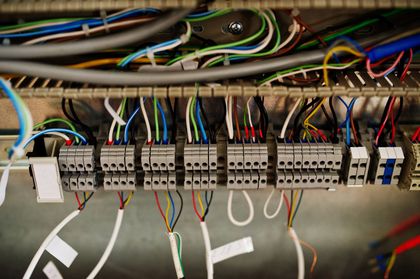 Close-up of server rack with multiple connected network cables of various colors, indicating data transfer and connections.