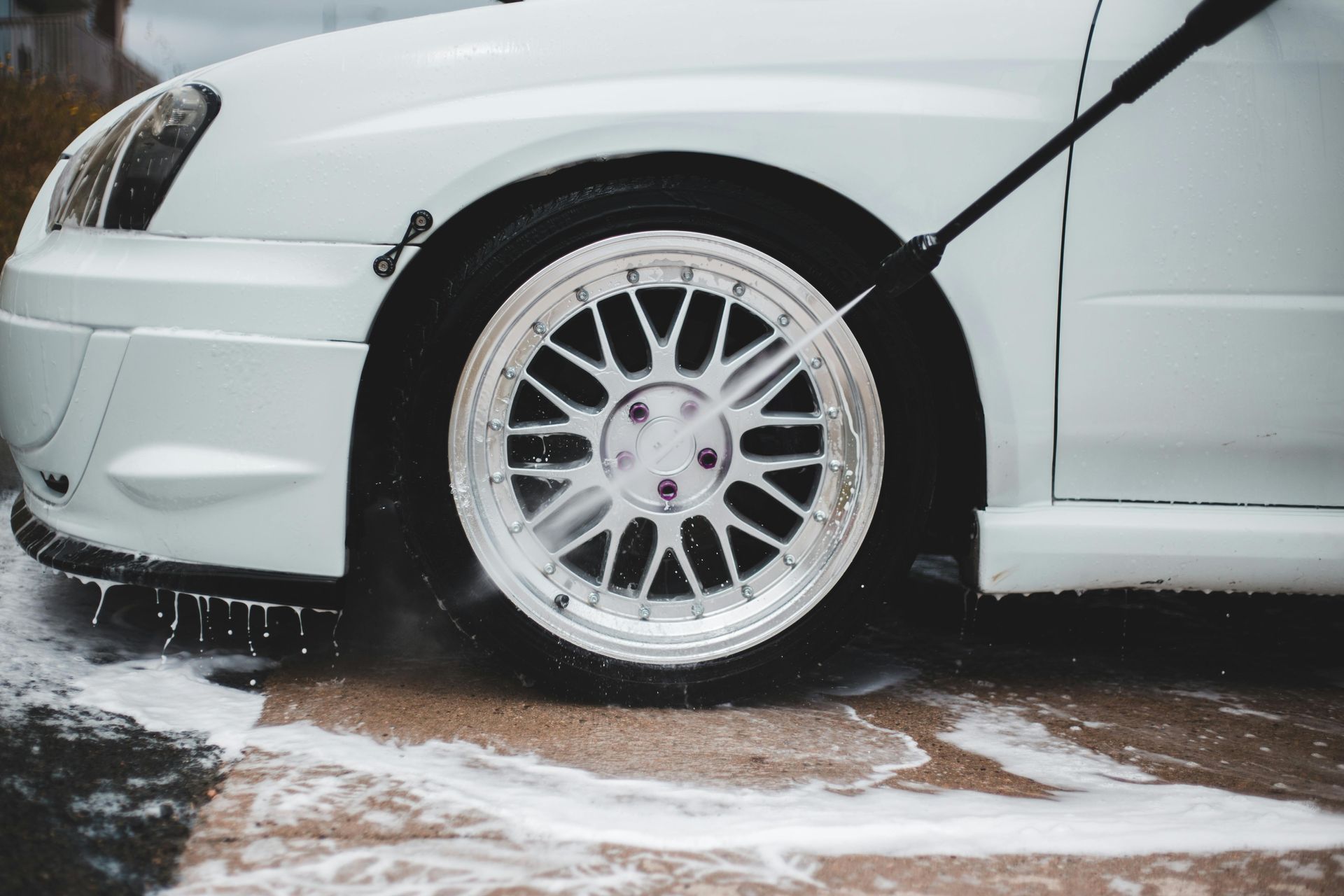 pressure washing a car wheel 