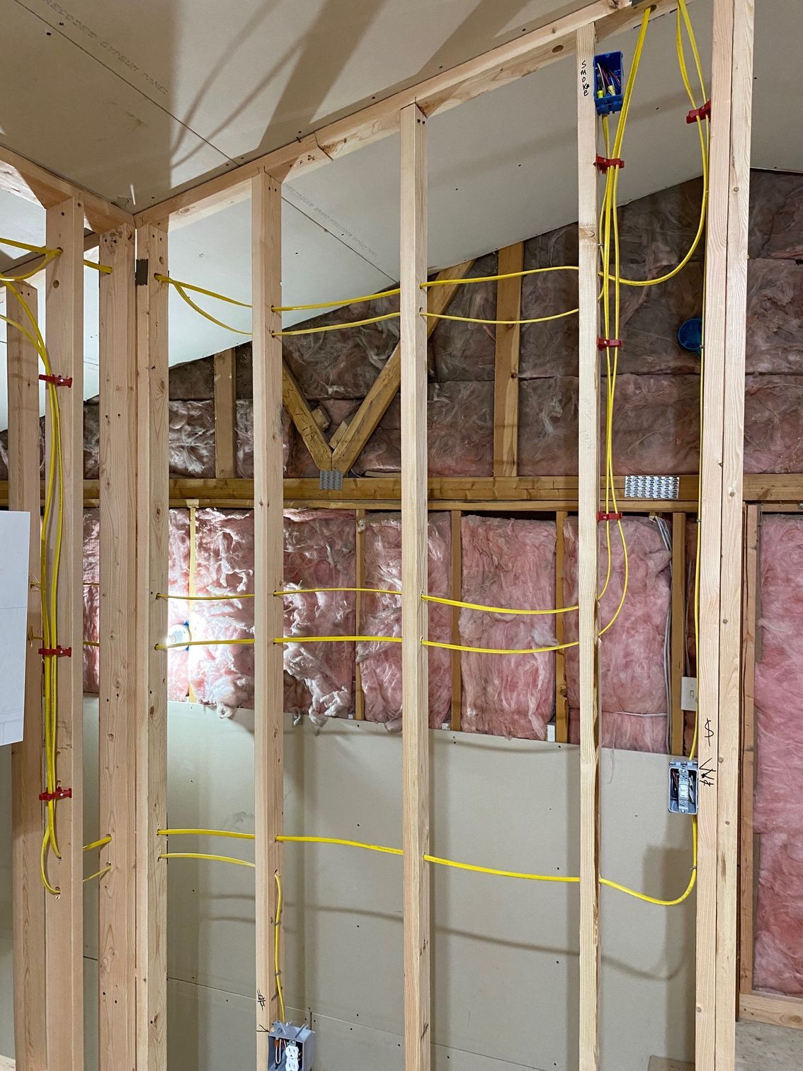 A person is installing a light switch on a wall.