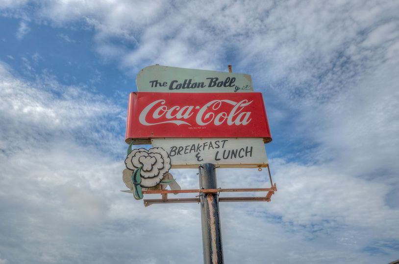 A coca cola sign with a chef on it