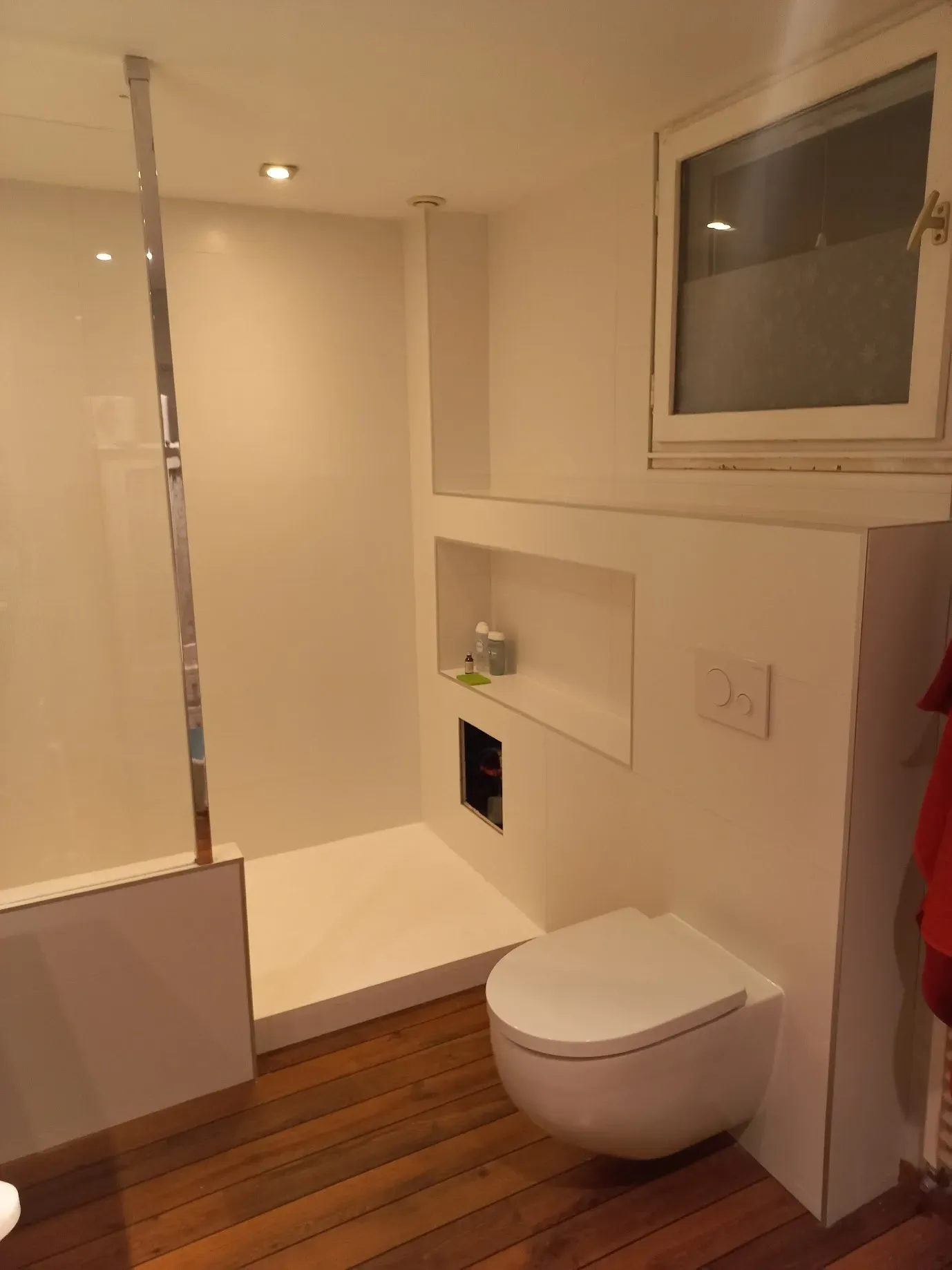 une salle de bain avec toilettes et fenêtre