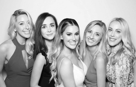 Bride and bridesmaids using the Glam photo booth rental at a local wedding venue