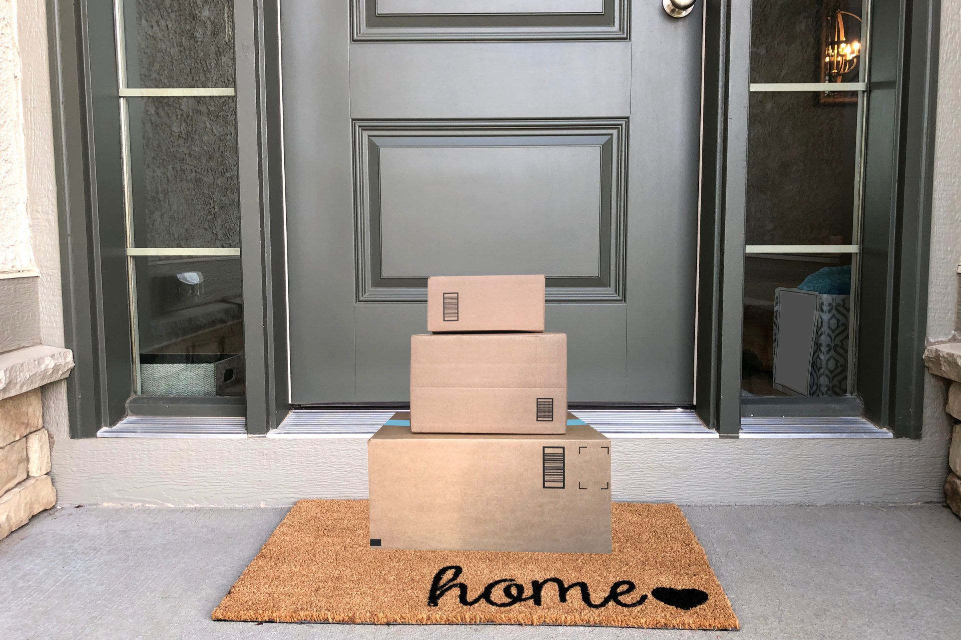 Three cardboard boxes are stacked on top of each other in front of a door.