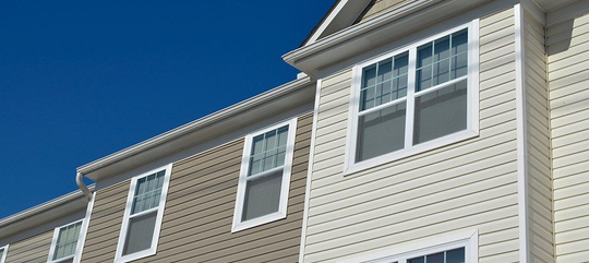 A row of houses with a blue sky in the background