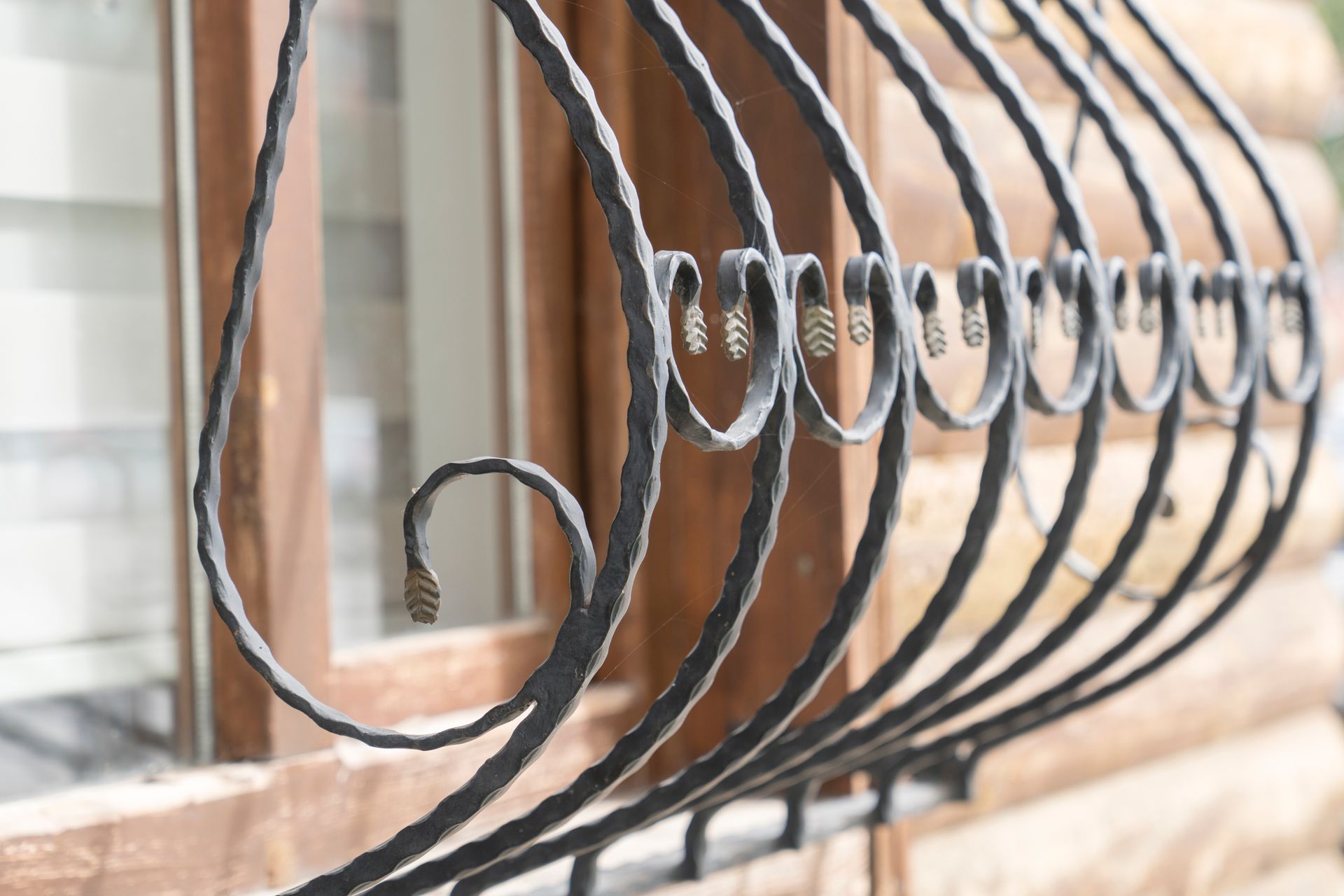 A close up of a wrought iron railing on a window