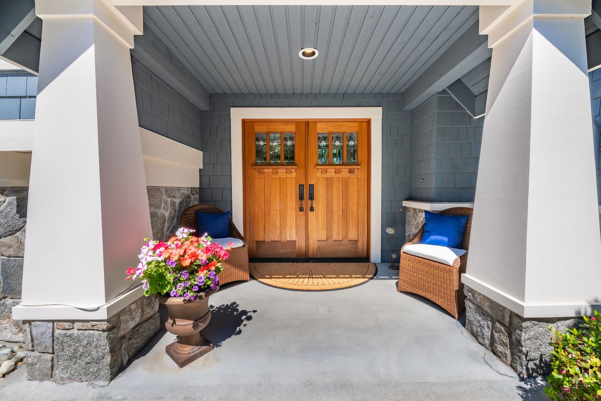 The front door of a house with a planter of flowers in front of it