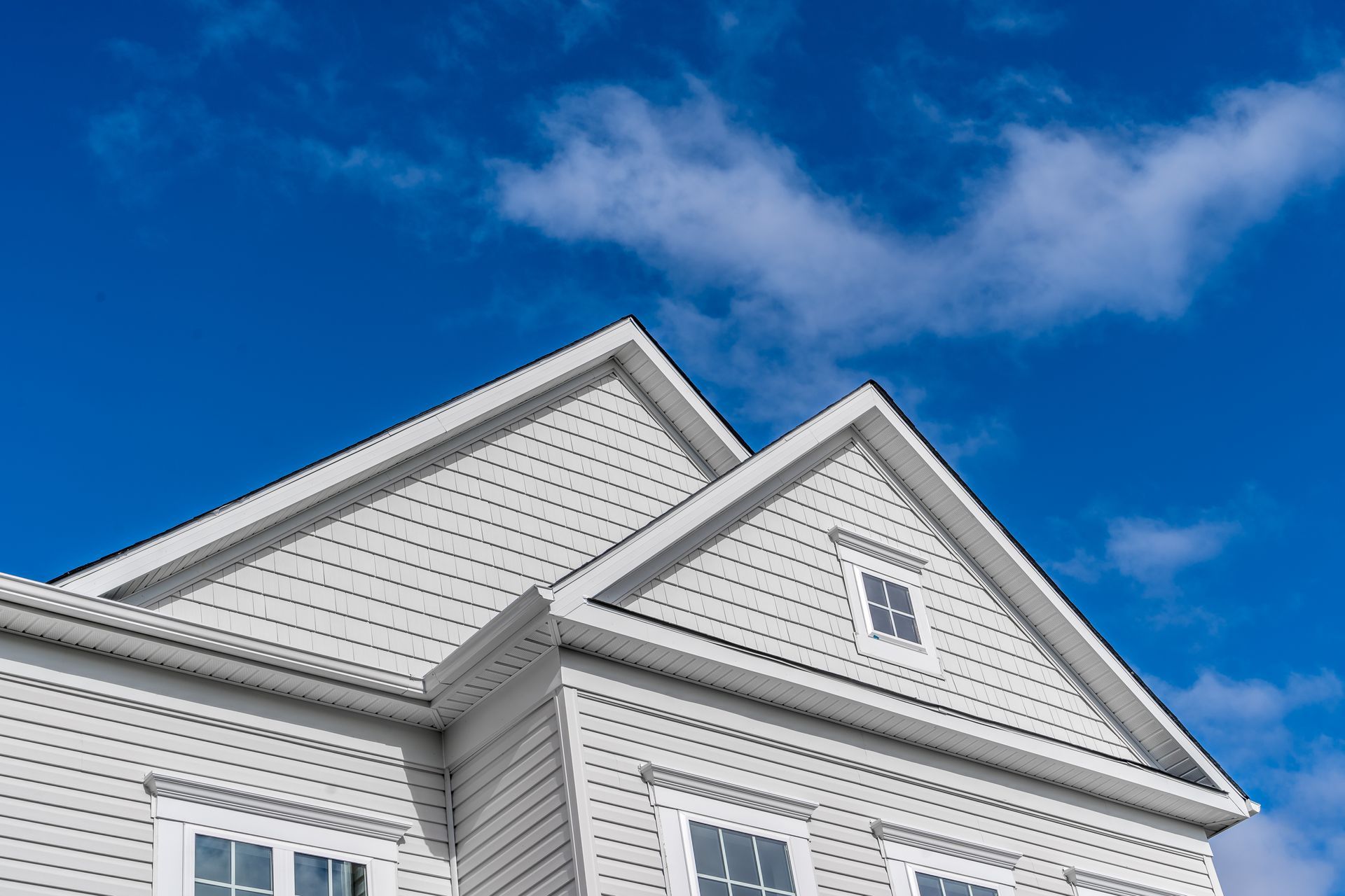 A white house with a blue sky in the background