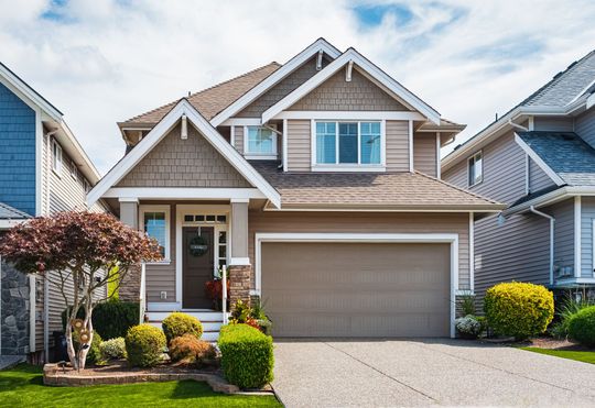 A house with a garage and a driveway in front of it