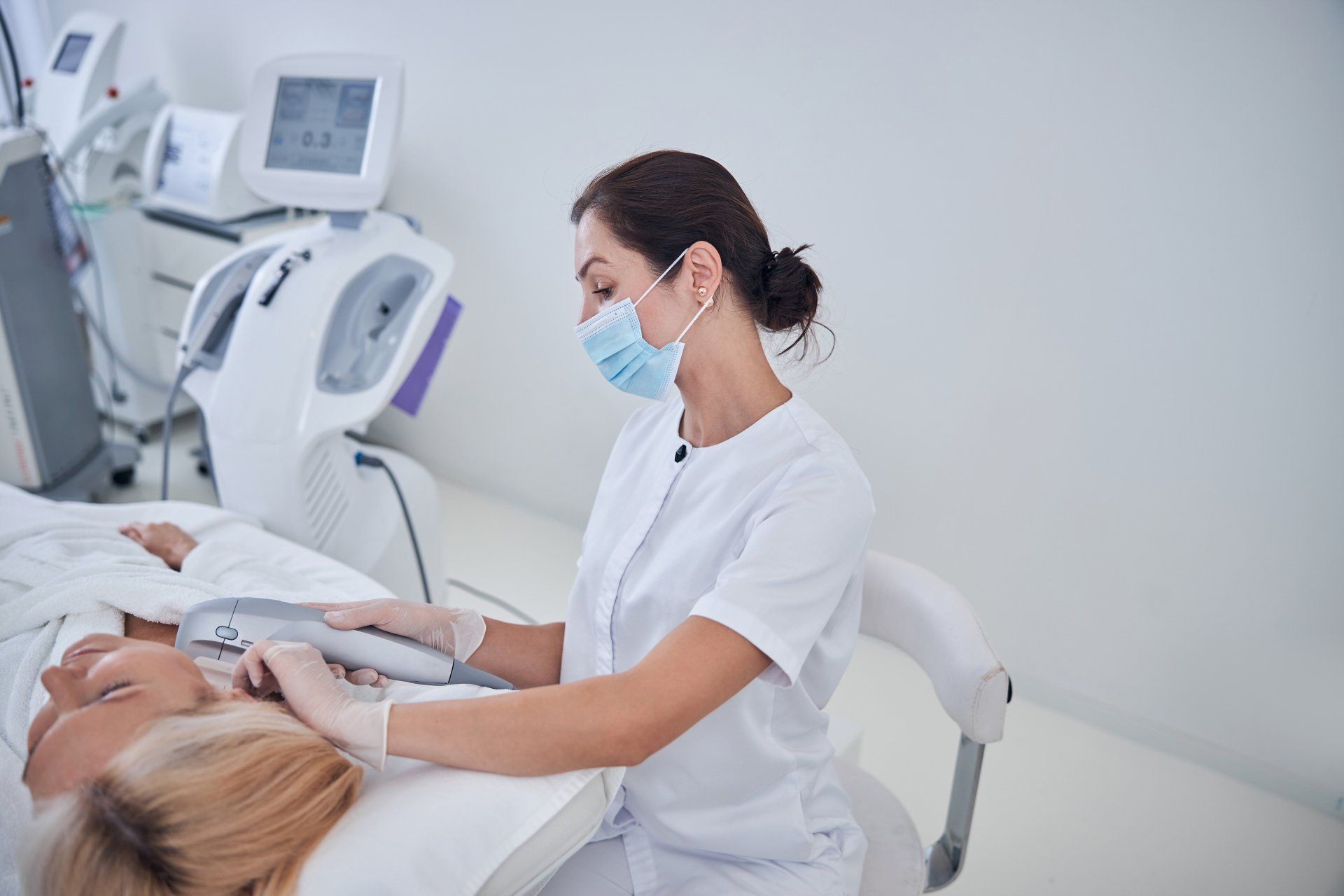 A woman is getting a facial treatment in a beauty salon.