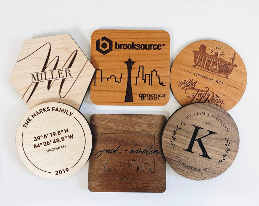 A group of wooden coasters are sitting on top of each other on a table.