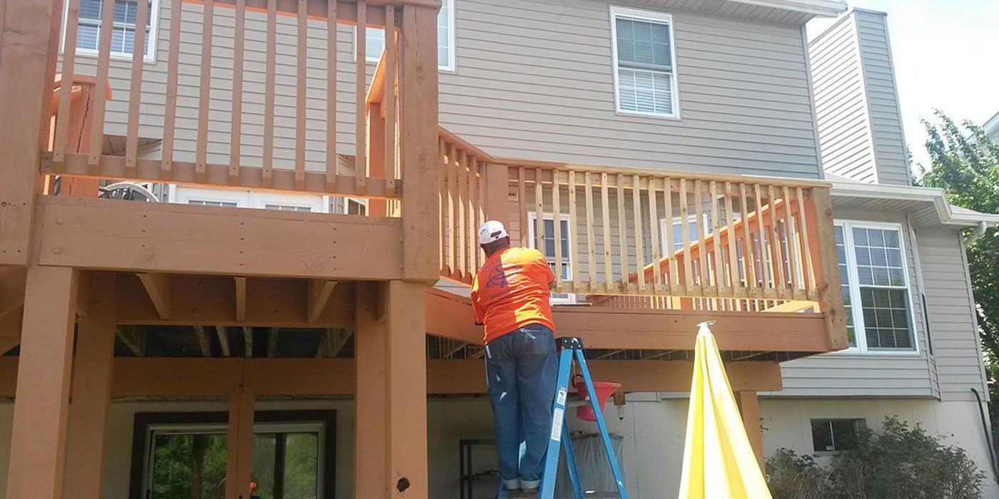 Man Painting House Deck