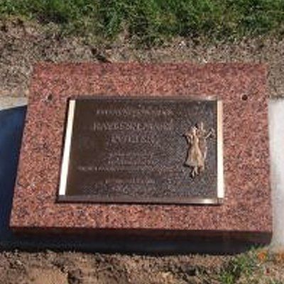 reclining red granite headstone