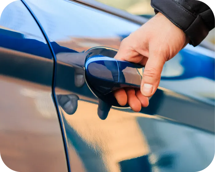 Hands of an electrician wiring a light switch, with visible colored wires and a wall outlet box.