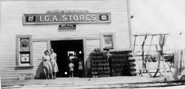 A black and white photo of a store called i.g.a. stores