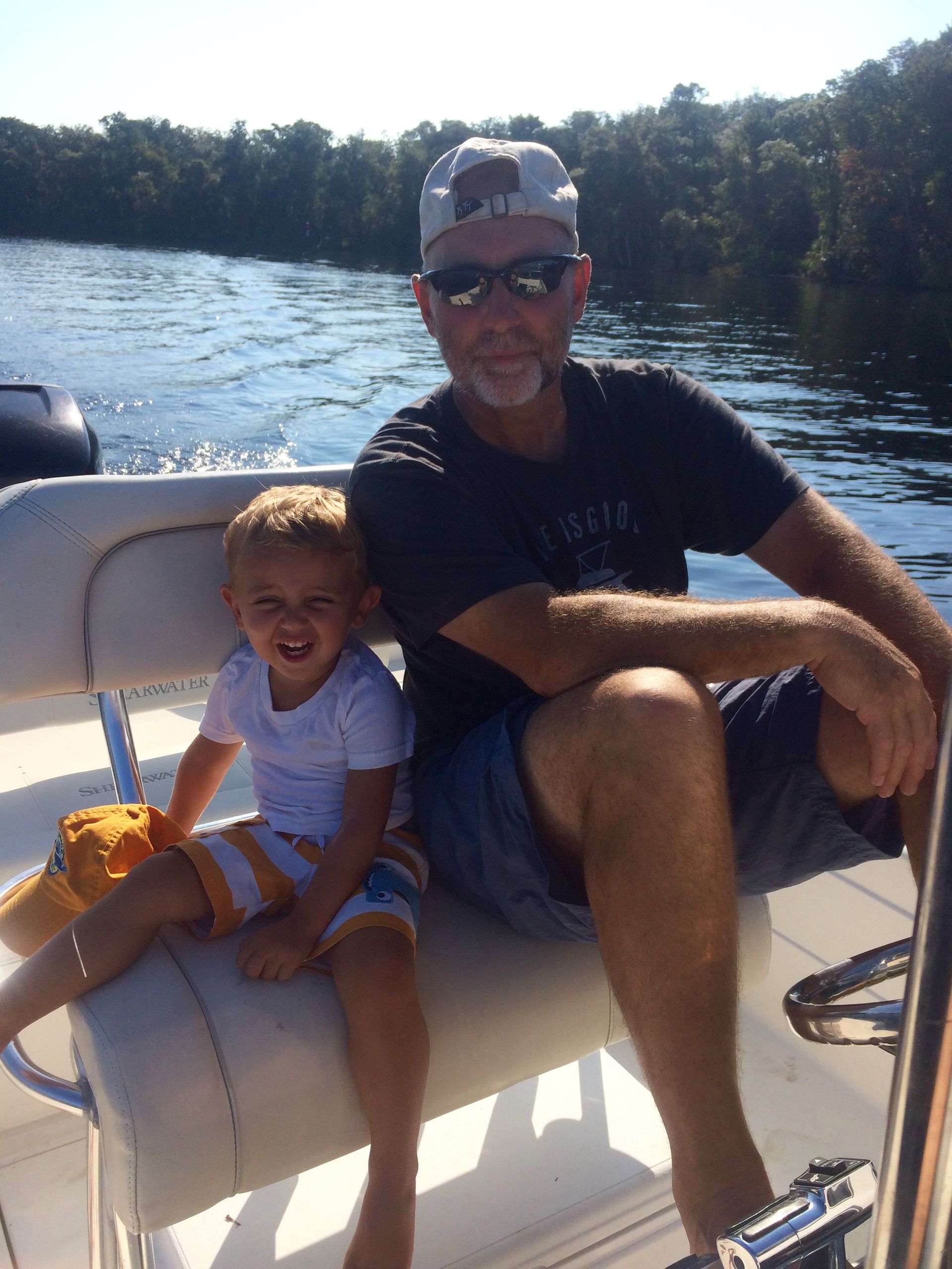 A man and a child are sitting on a boat