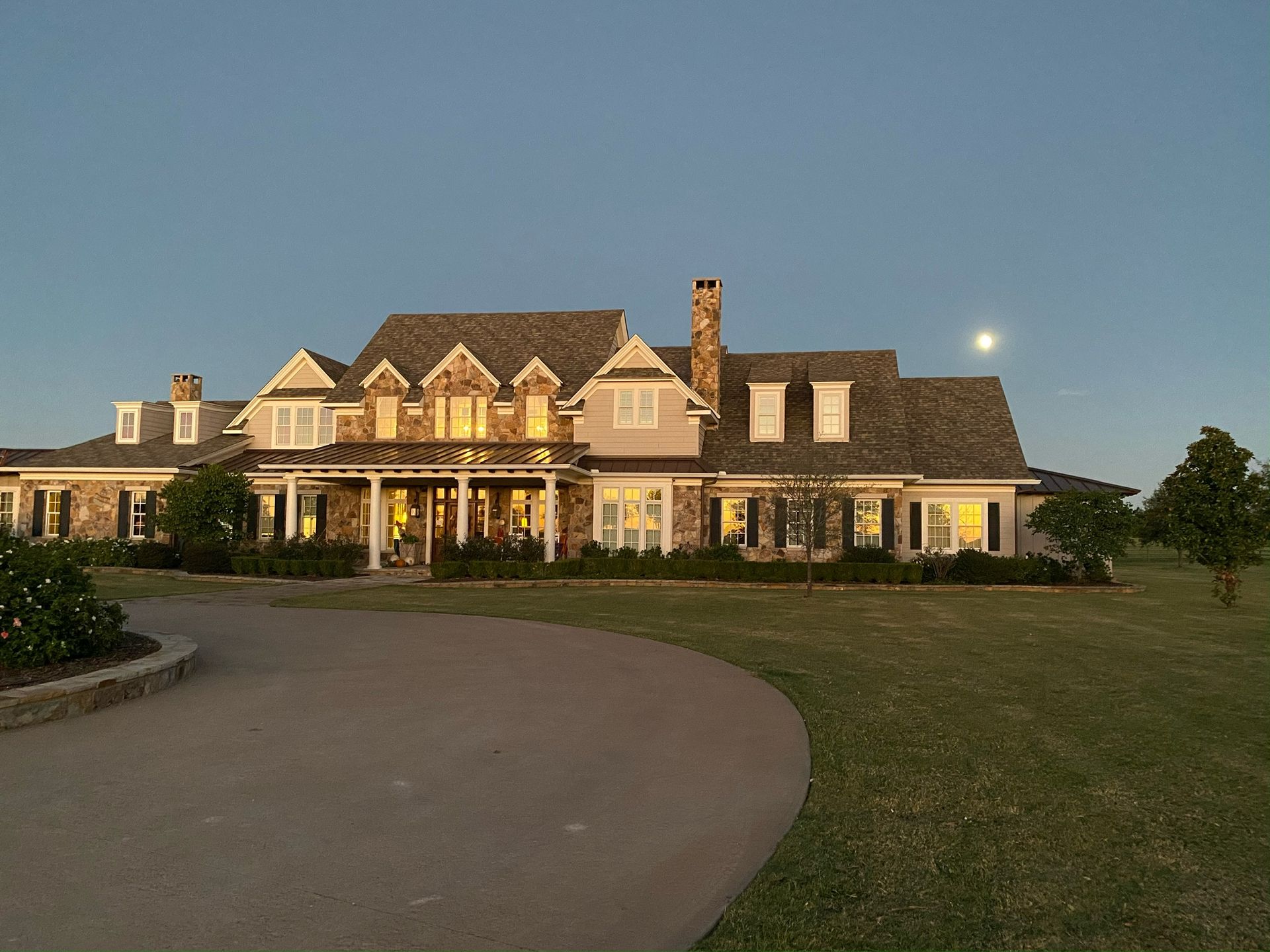 A large house with a full moon in the background
