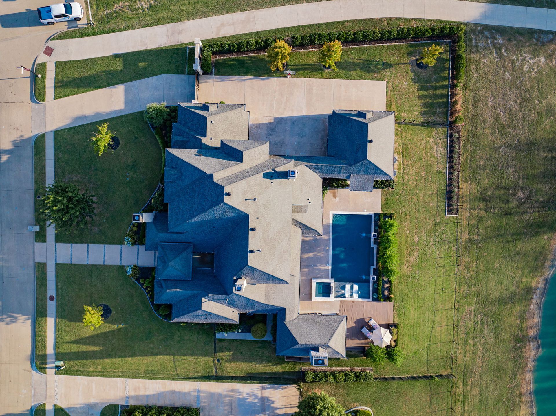 An aerial view of a large house with a swimming pool