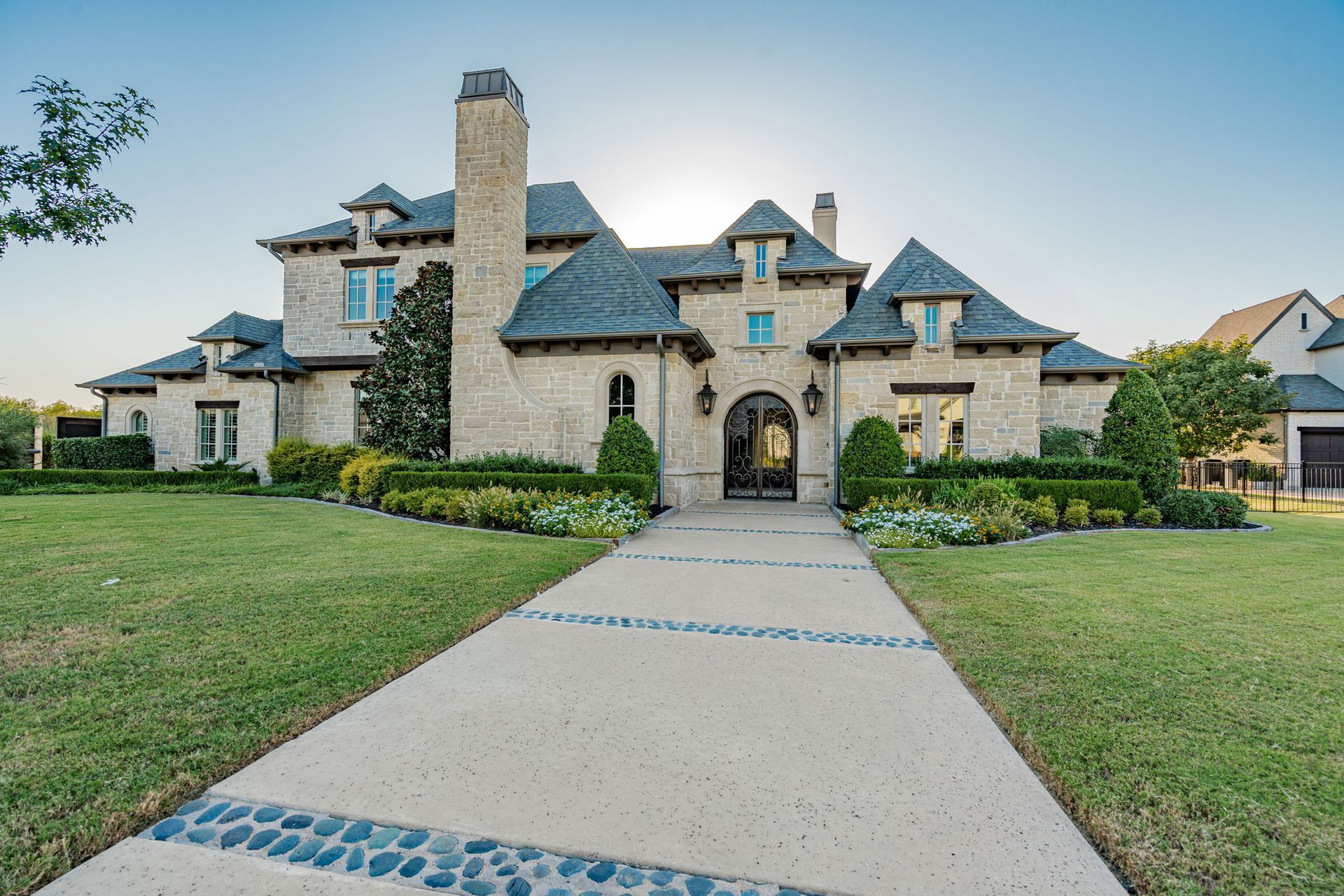 A large house with a concrete driveway leading to it.