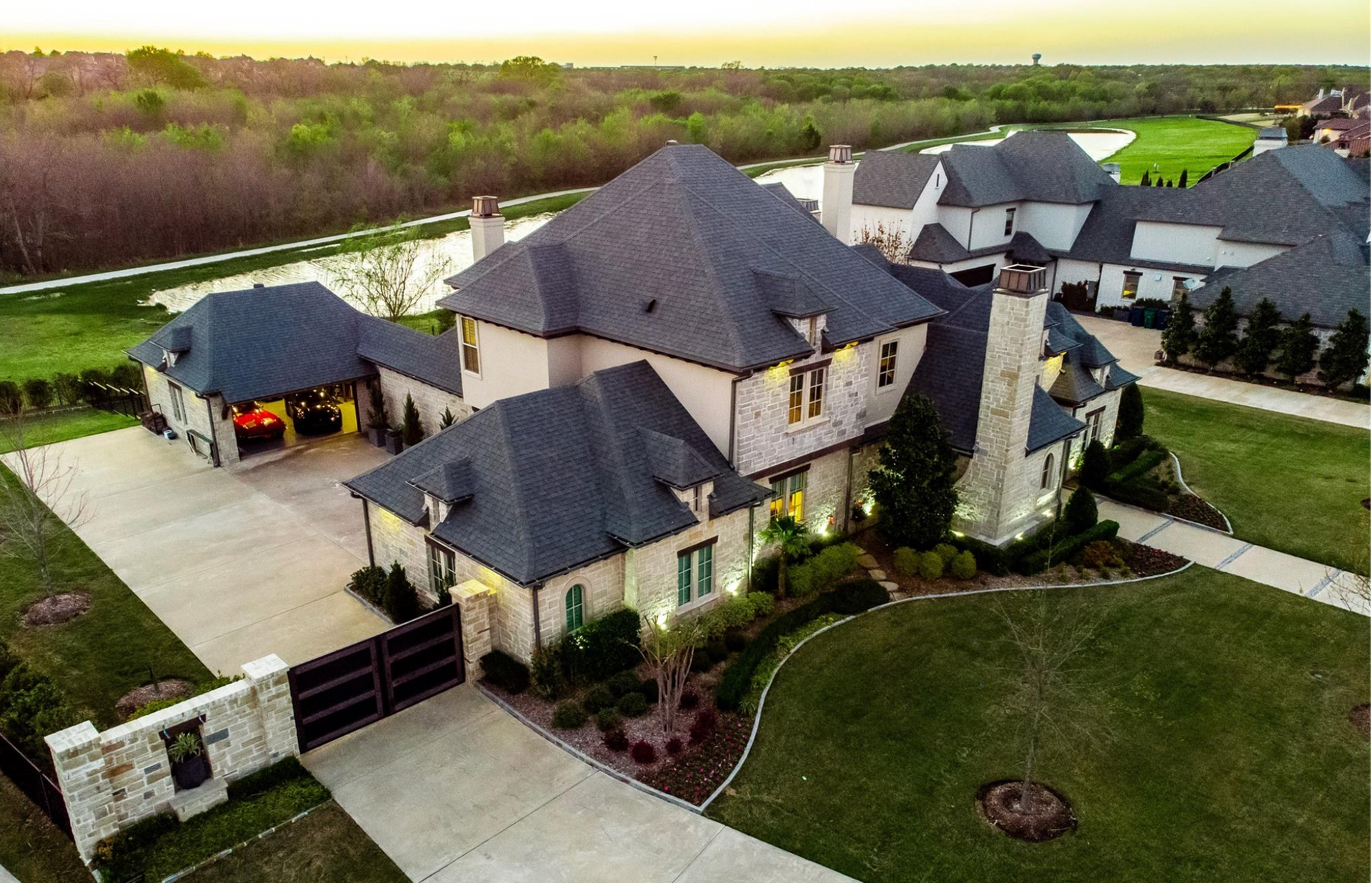 An aerial view of a large house with a large driveway