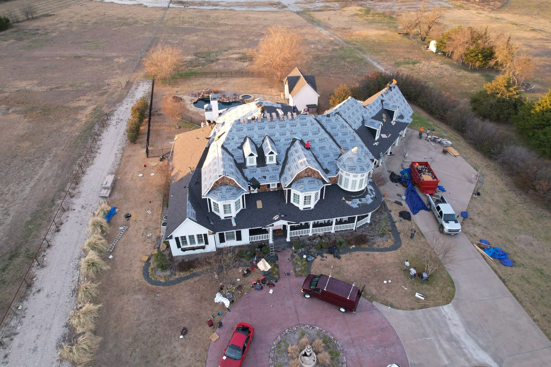 An aerial view of a large house that has been damaged by a tornado.