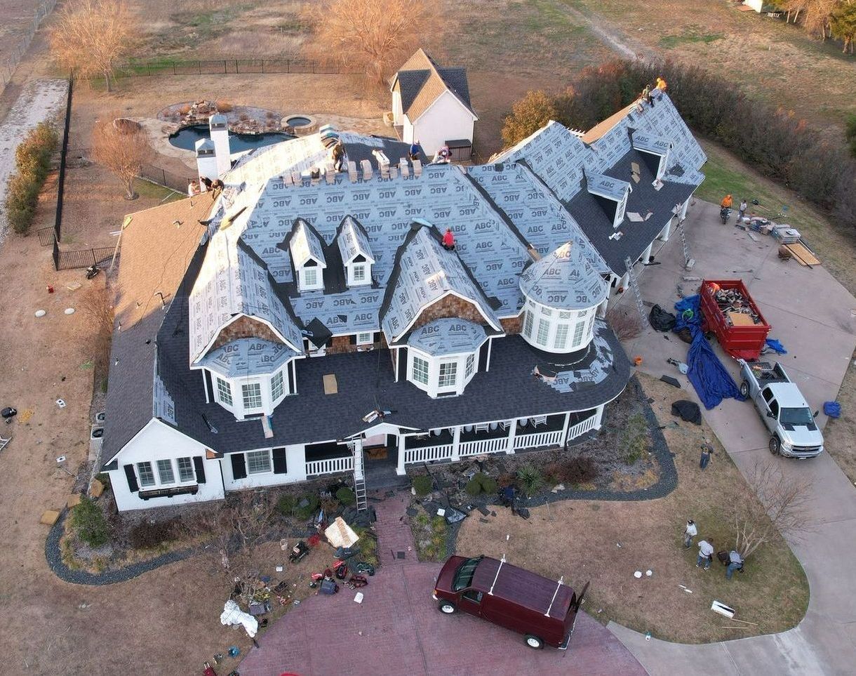 An aerial view of a large house under construction