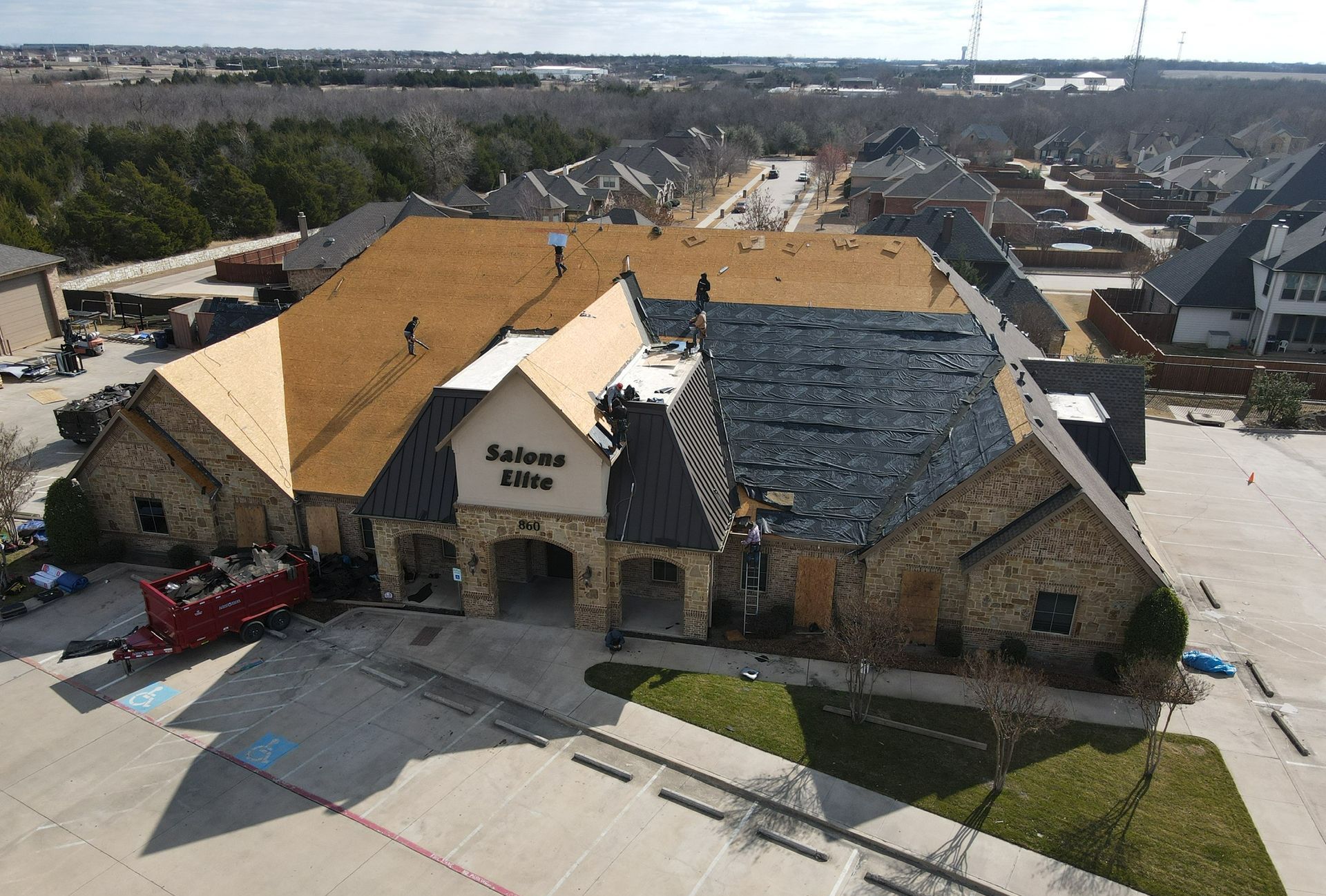 An aerial view of a building with a roof that is being installed