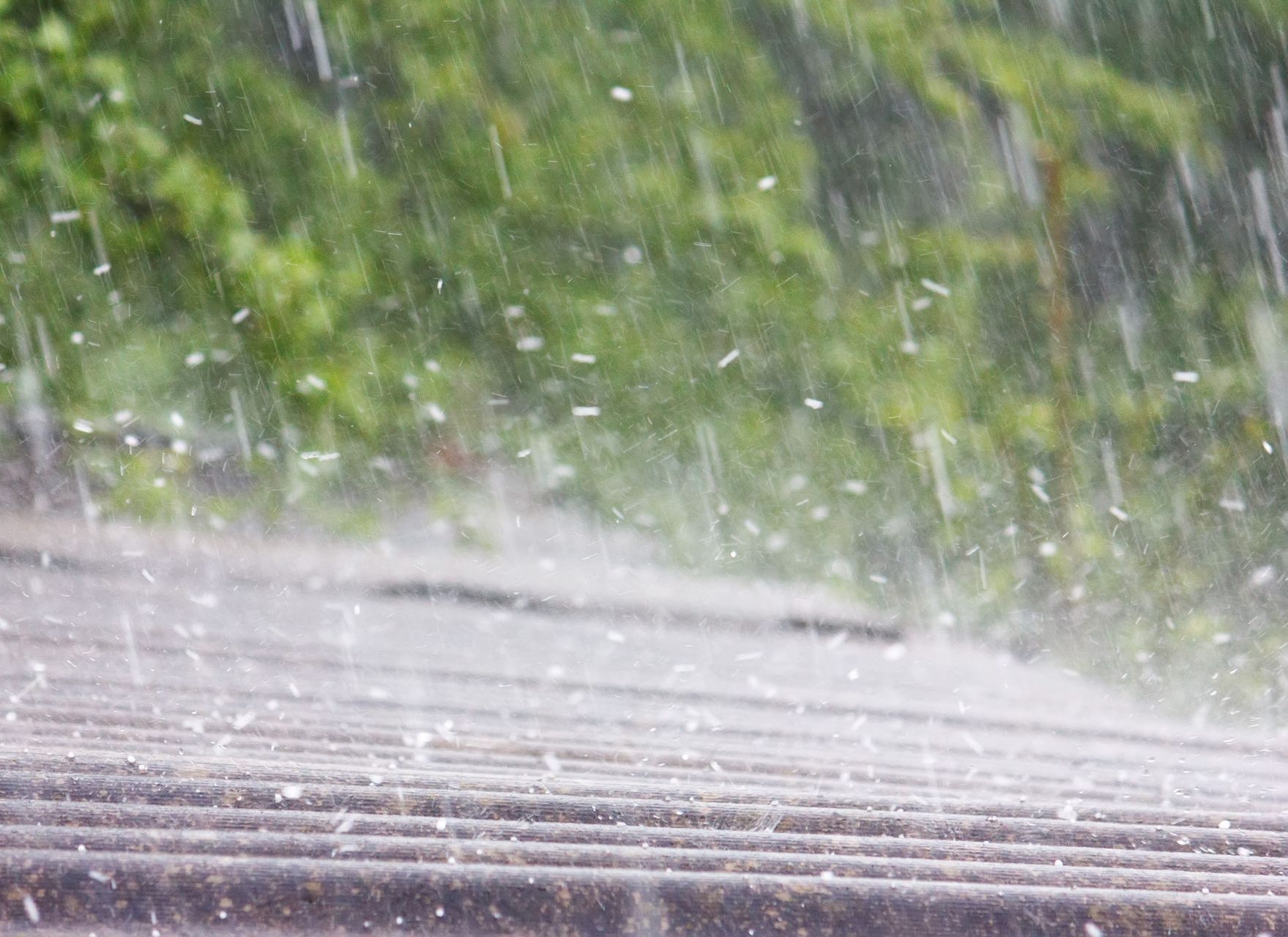 A close up of rain falling on a roof