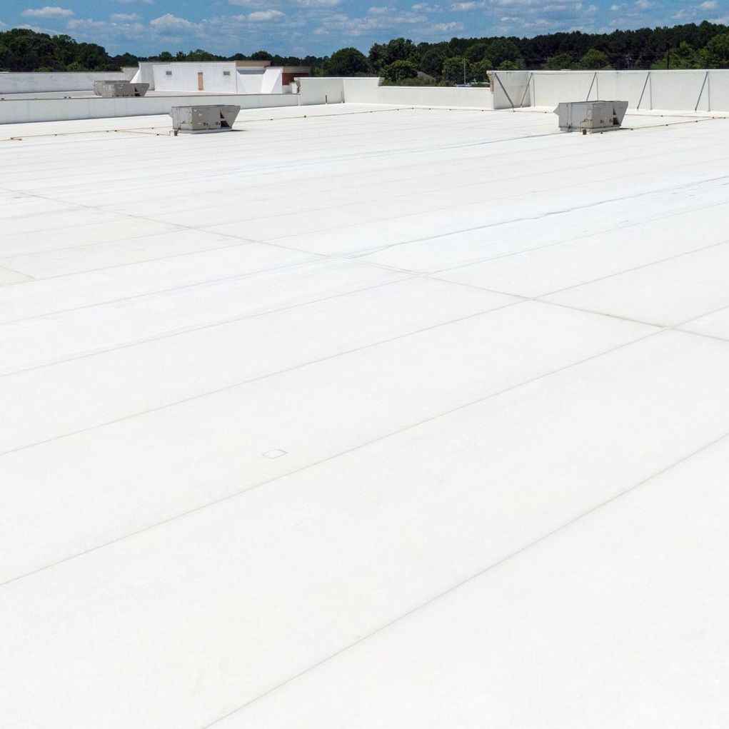 A large white roof with a blue sky in the background.