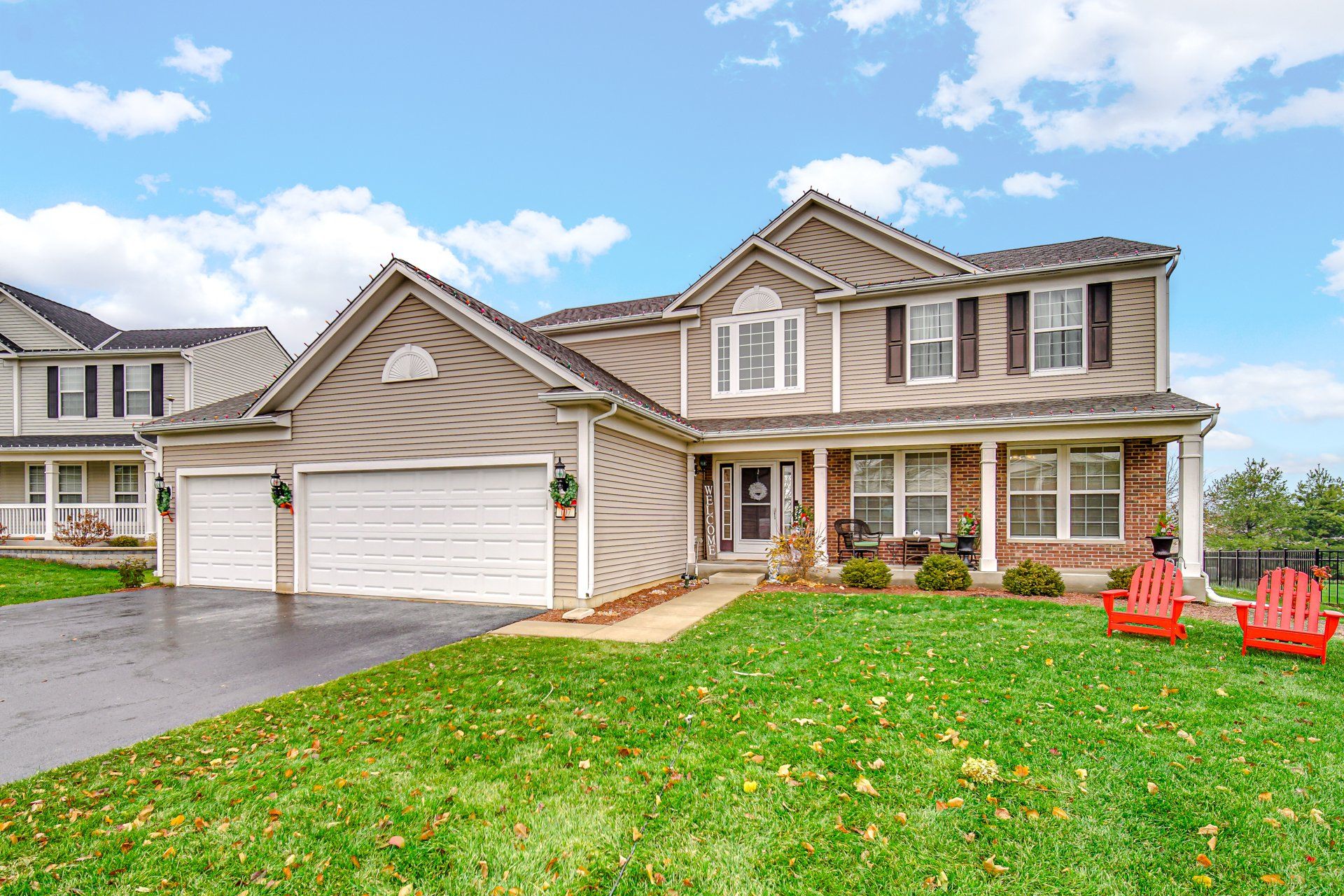 A large house with a lot of red chairs in front of it.