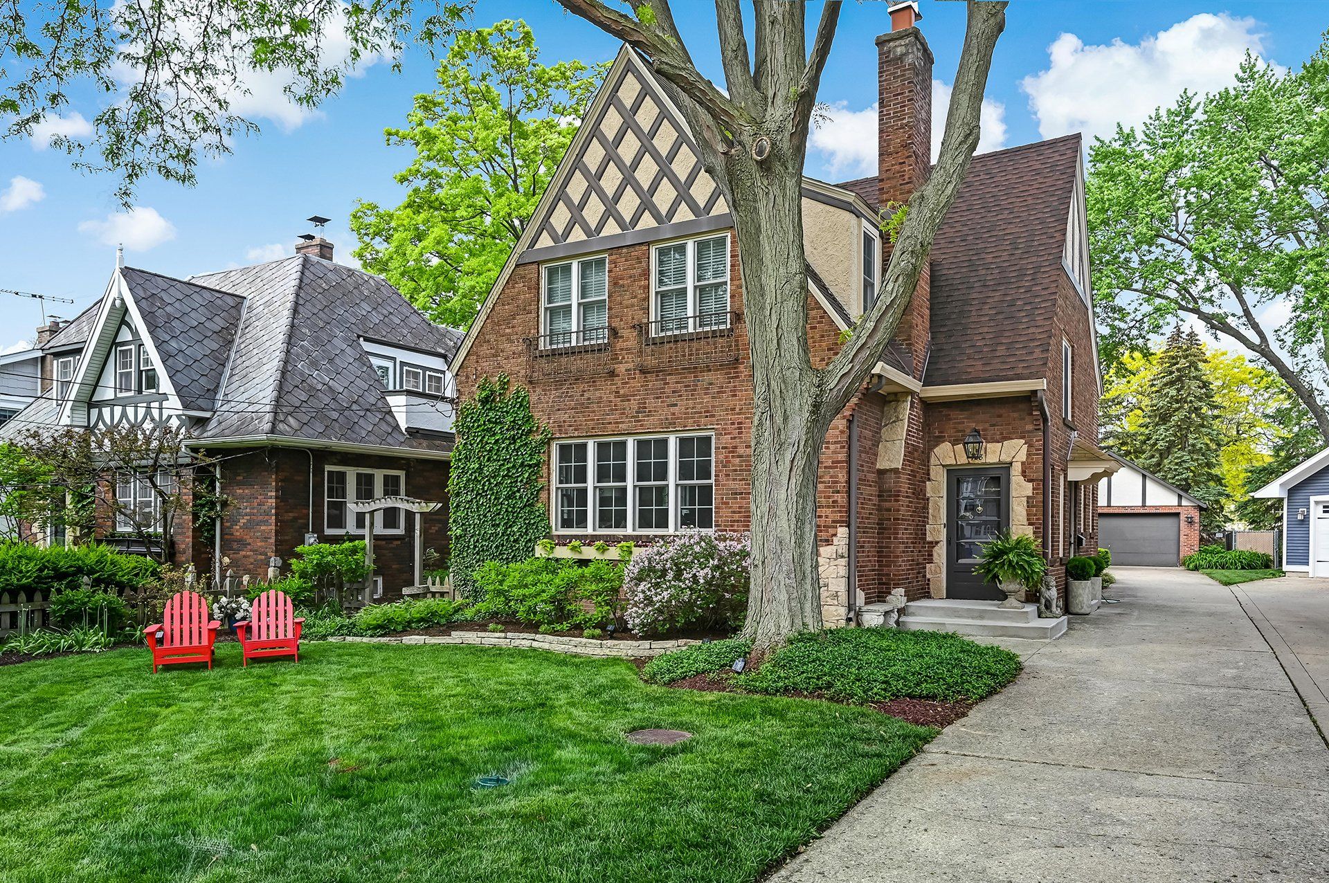 A large brick house with a red chair in front of it.