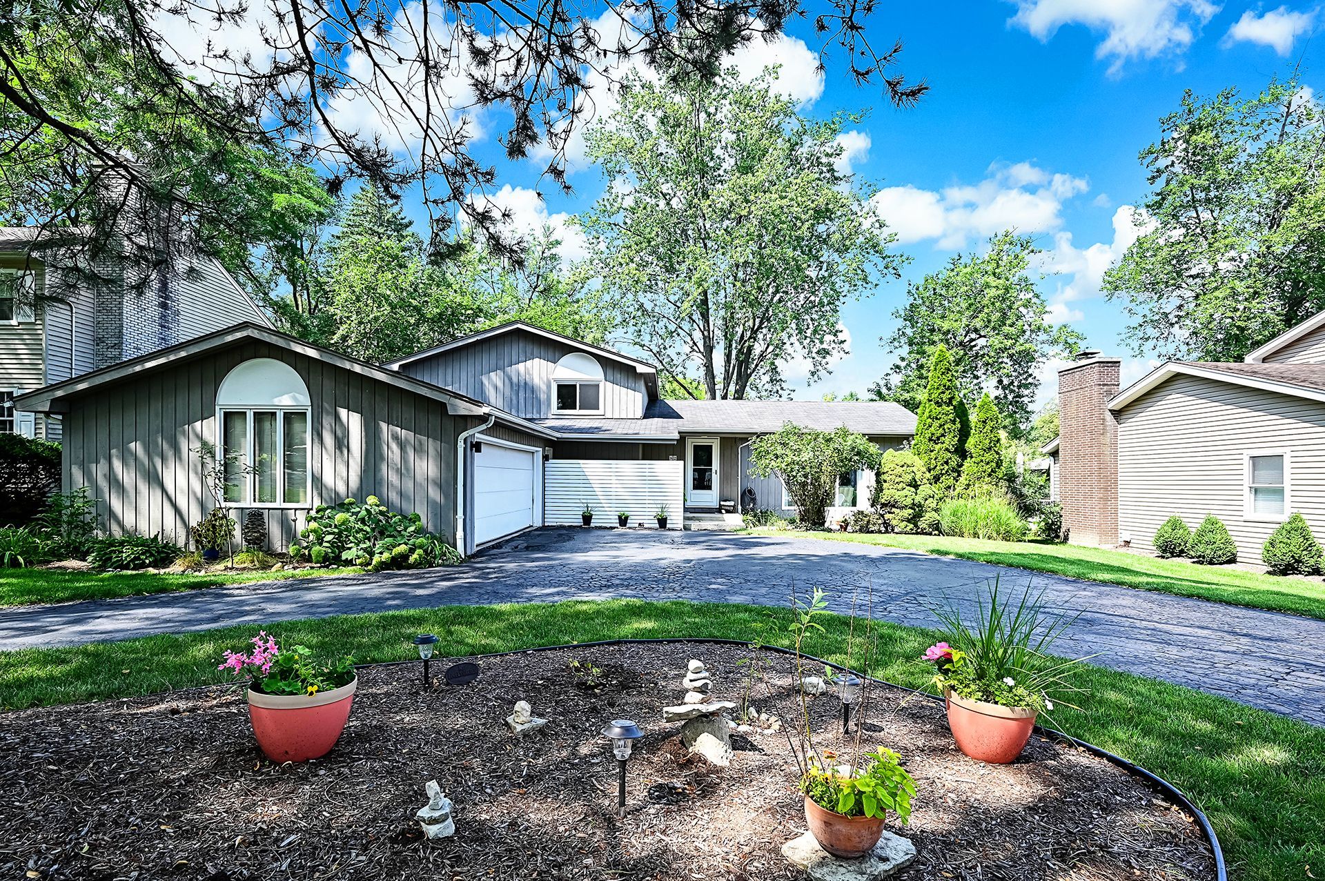 A house with a lot of flowers in front of it