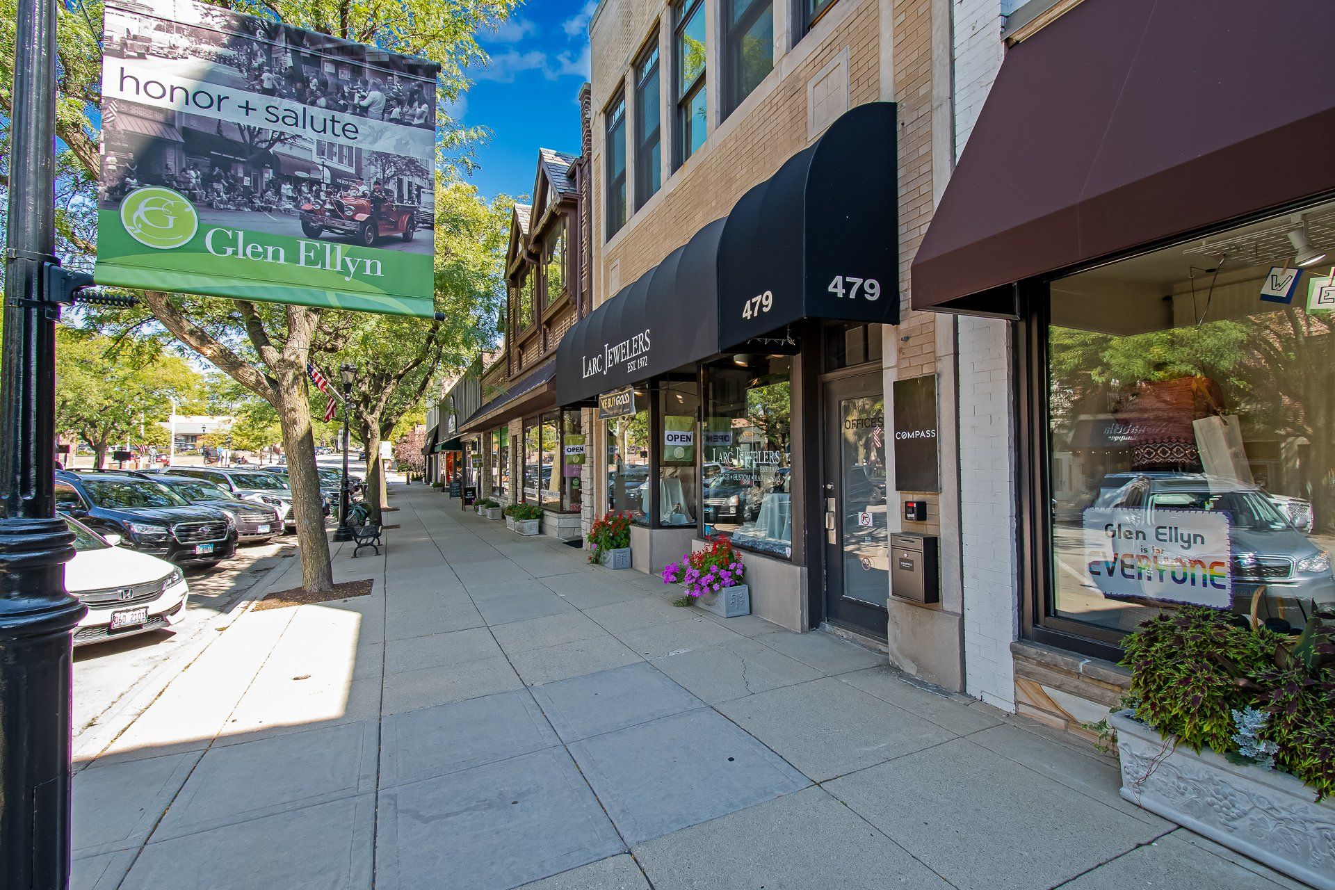 A row of stores on a city street with a sign that says chrysler