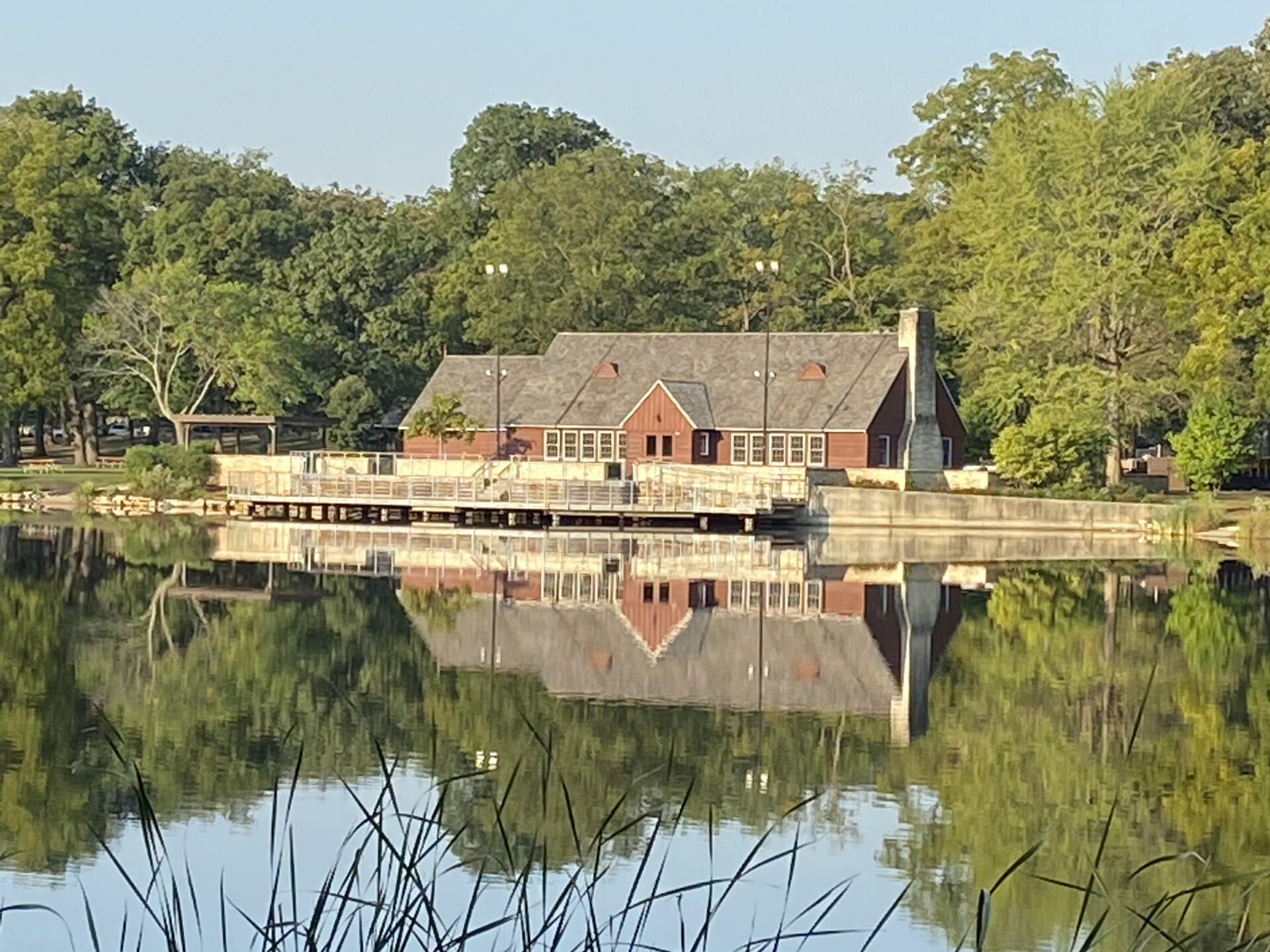 A house is reflected in the water of a lake
