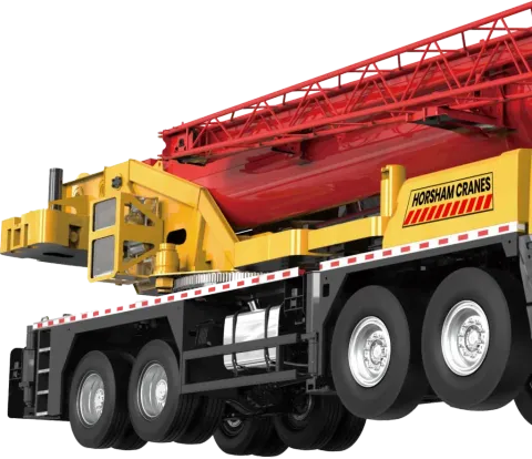 Red and yellow construction crane with multiple wheels, labeled