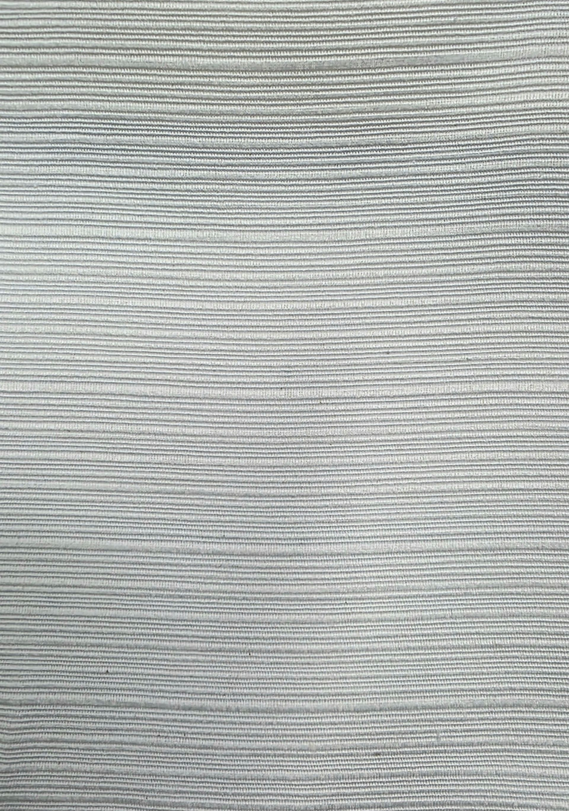 Un primer plano de un trozo de tela gris.