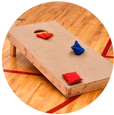 A wooden cornhole board with red and blue bags on it